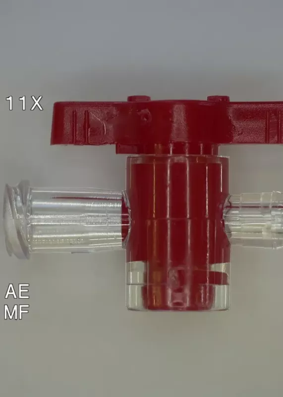 Czerwony plastikowy zawór medyczny oglądany w&nbsp;powiększeniu 11× na mikroskopie cyfrowym INSPEX 4K